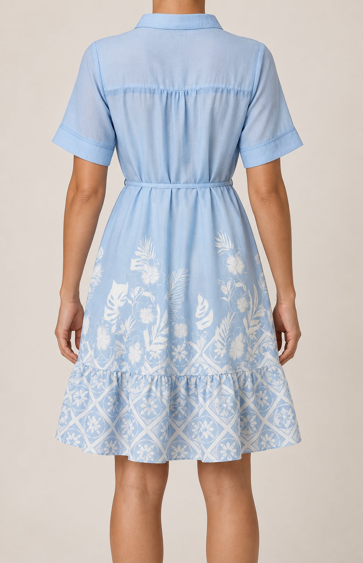 Back view of the SOGNA blue botanical border-print linen-blend dress 46260344-1, showing the gathered yoke and flounced hem.