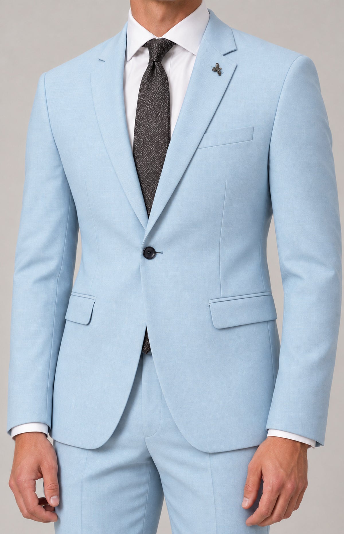Close-up of the Quinn 1907 jacket in Ice, showing notch lapels, chest welt pocket, single-button fastening and flap pockets. Jacket only.