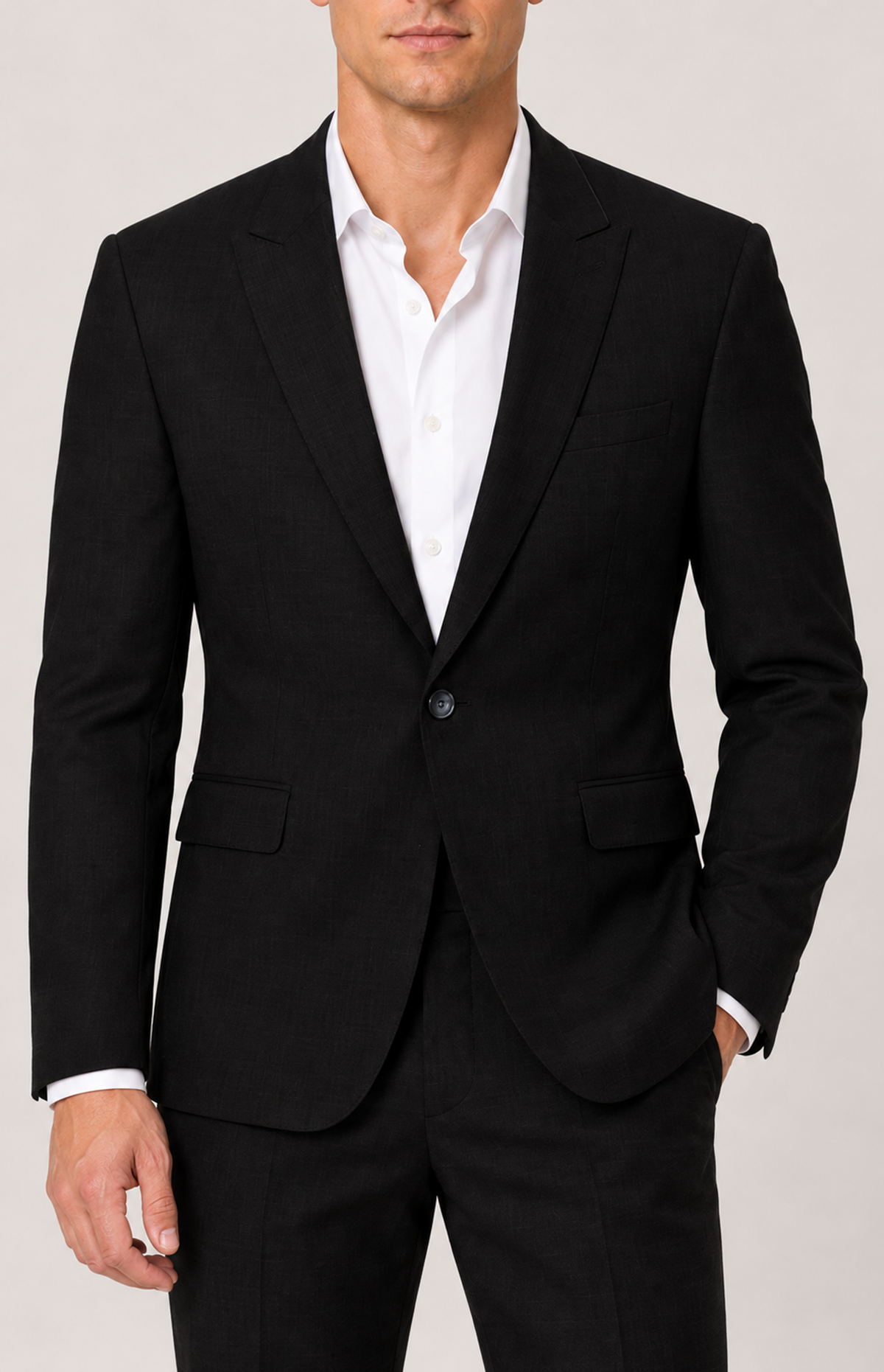 On-model detail of the black 2836 jacket notch lapels, chest welt pocket and single front button.