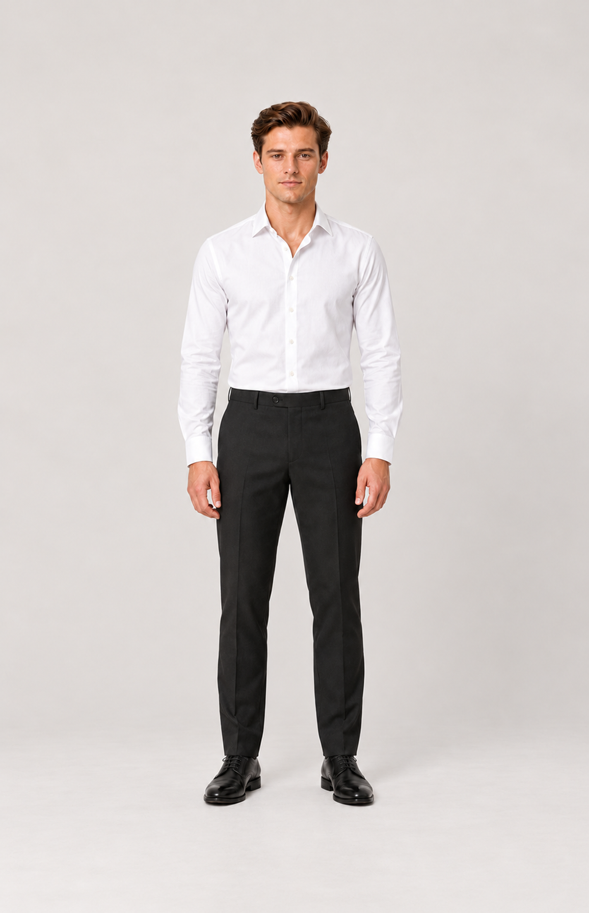 Front full-length model view of black 8228 fine-twill suit trousers, styled with a white shirt and black shoes.