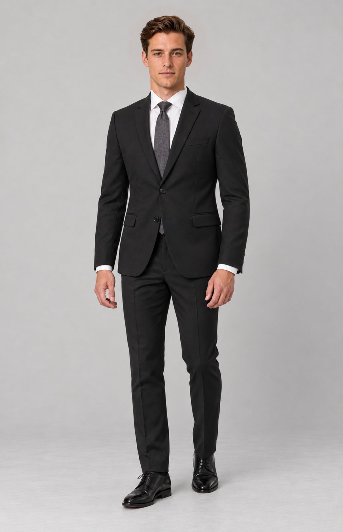 SOGNA T128 Black tailored jacket on M01, full-length relaxed standing view. Jacket only; shirt, tie, trousers and shoes are styling.