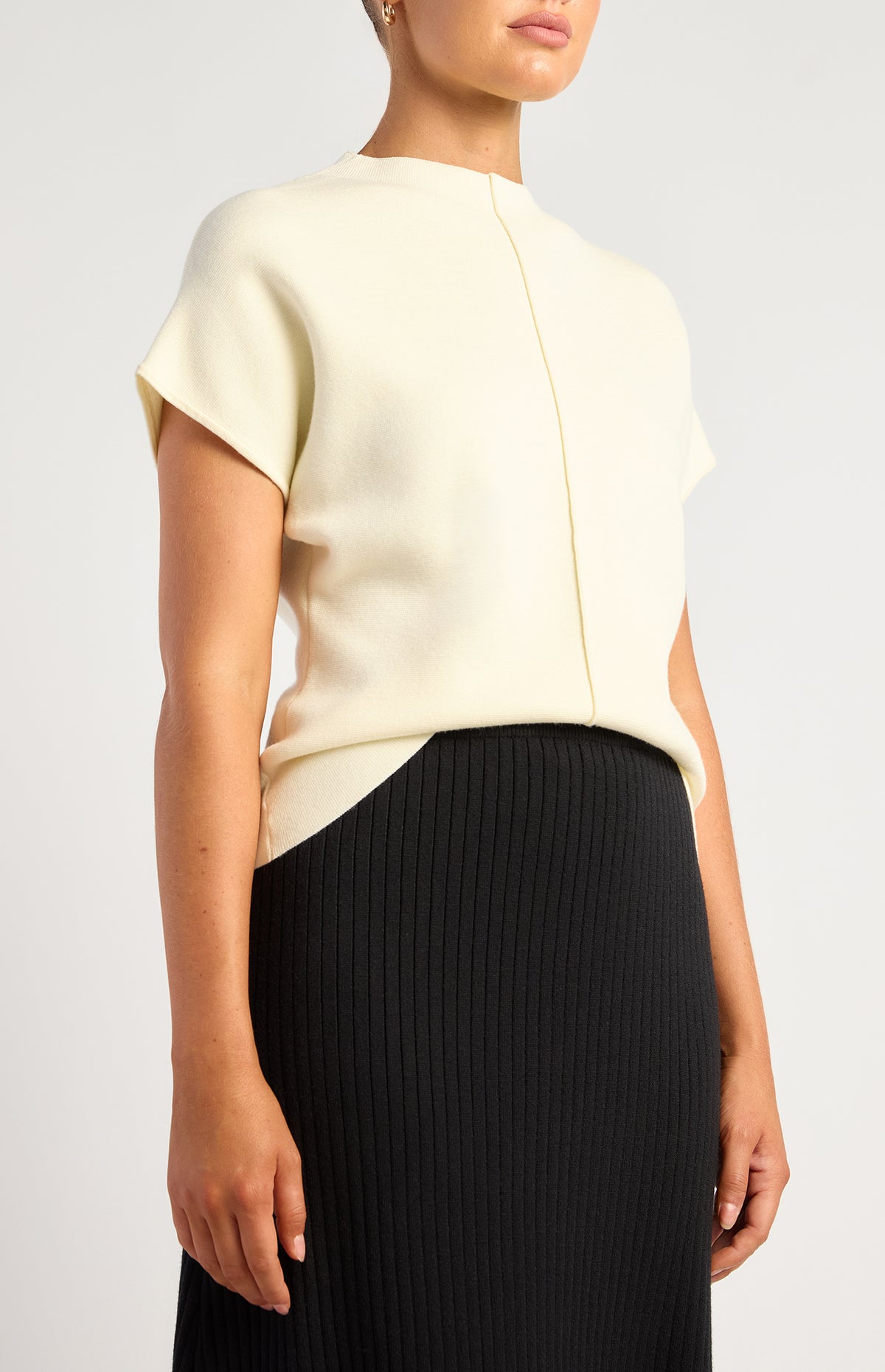 SKN967 white centre-seam knit top, angled front view