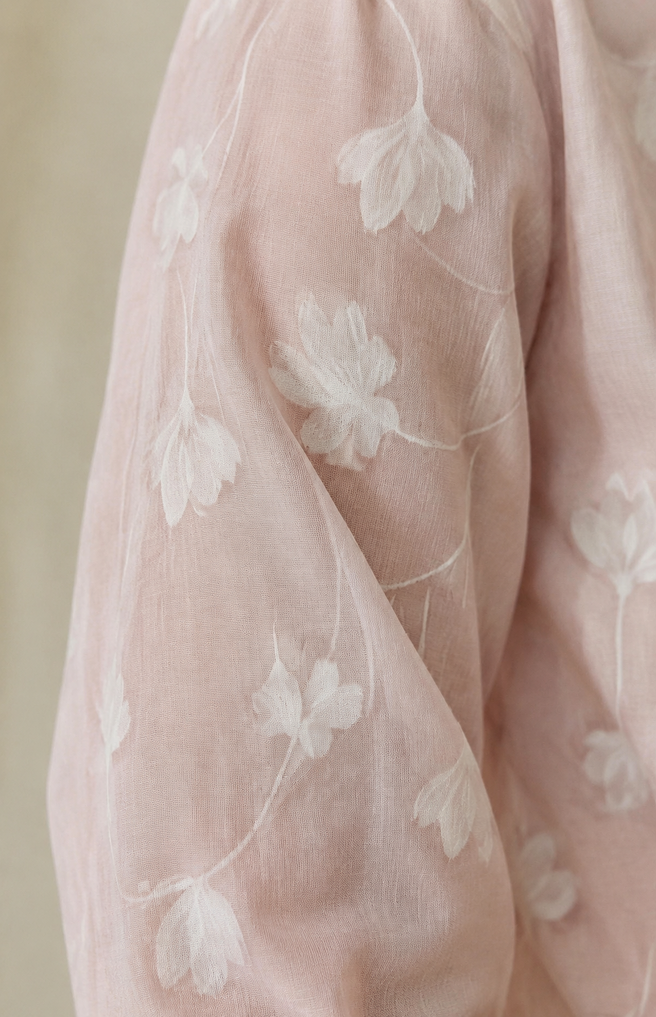 Close-up of pink fabric with white floral motif