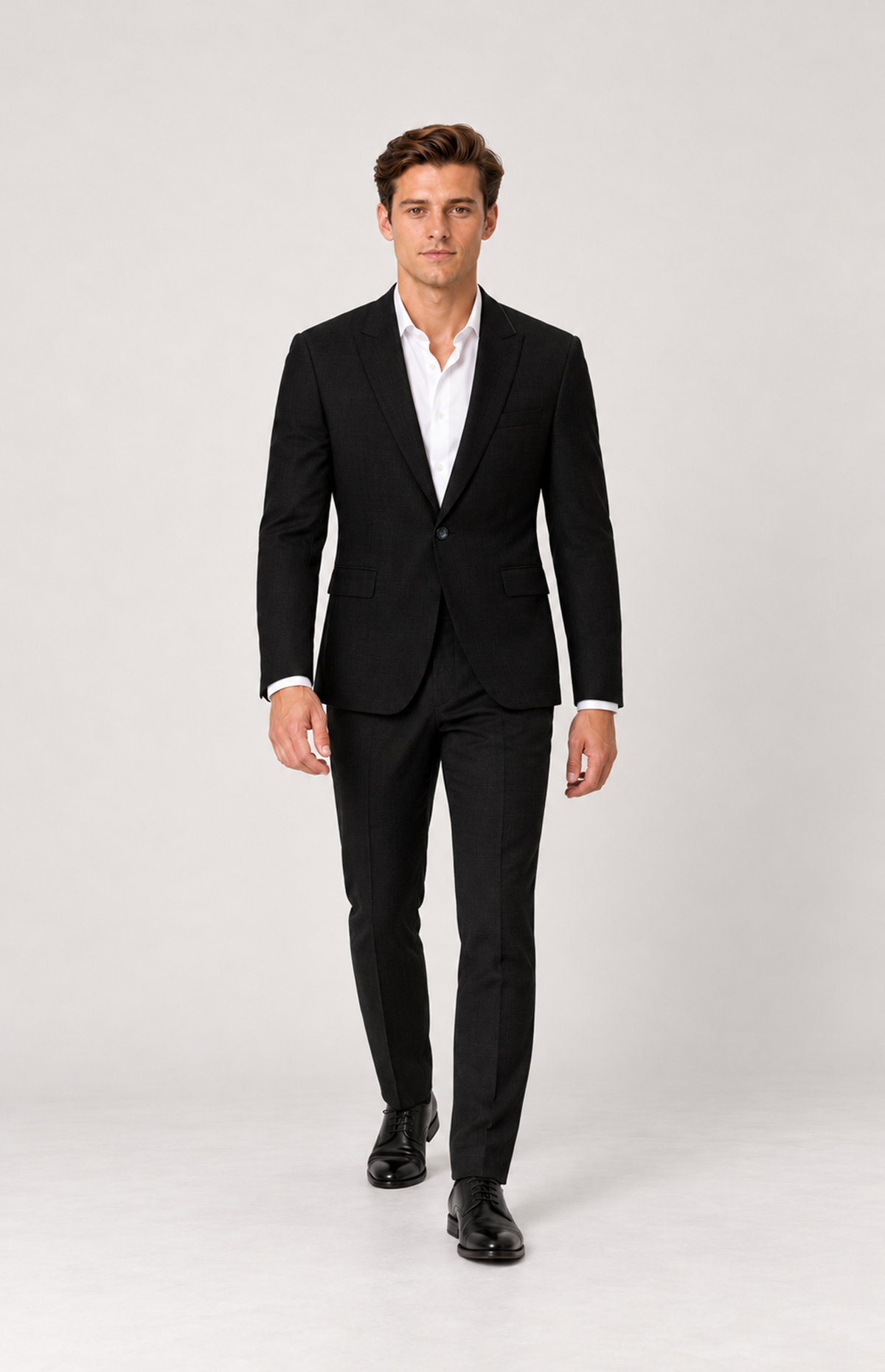 Walking full-length styling view of M01 wearing the black 2836 stretch suit jacket.