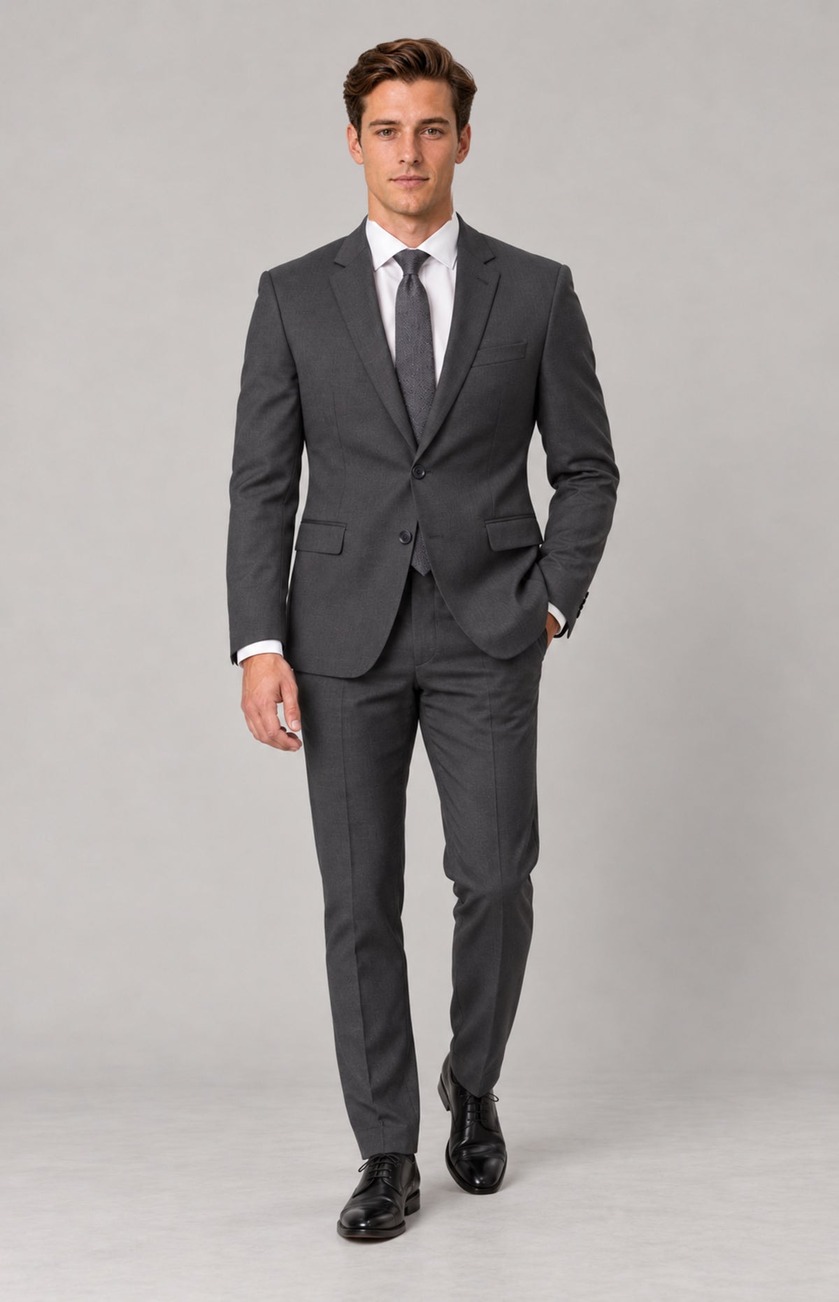 SOGNA T128 Charcoal tailored jacket on M01, full-length walking pose. Jacket only; shirt, tie, trousers and shoes are styling.