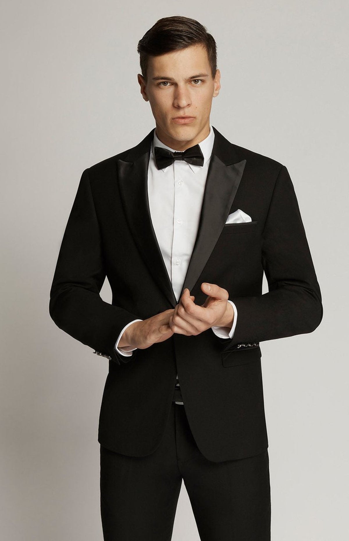 Black Satin-Lapel Dinner Jacket 1303 on model adjusting the cuff, front view